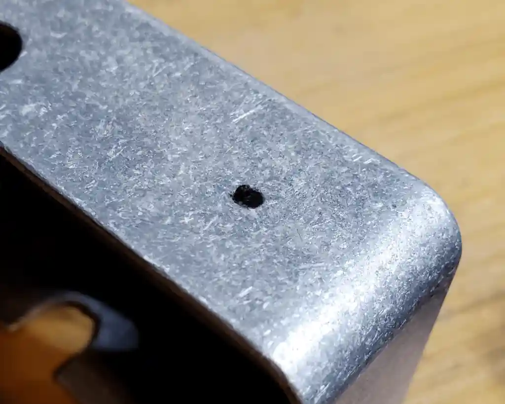 A sharpie marks the center point of the hole to be drilled into the pedal enclosure.