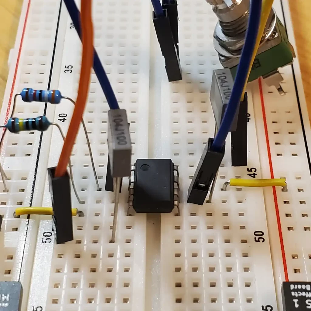 An op amp occupying the middle gap on a breadboard.